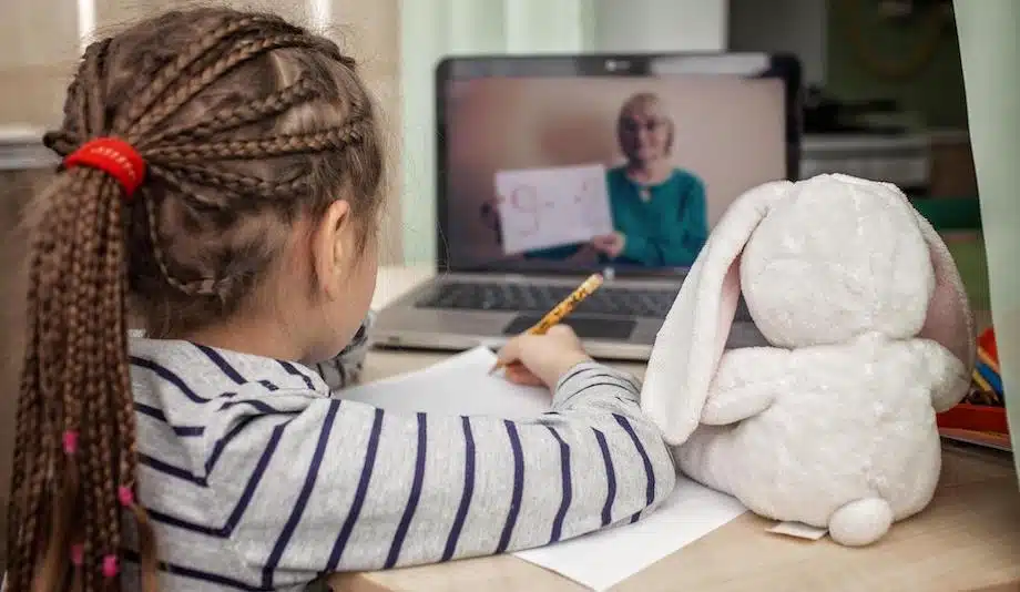 Student doing her online learning from a laptop in a virtual classroom.