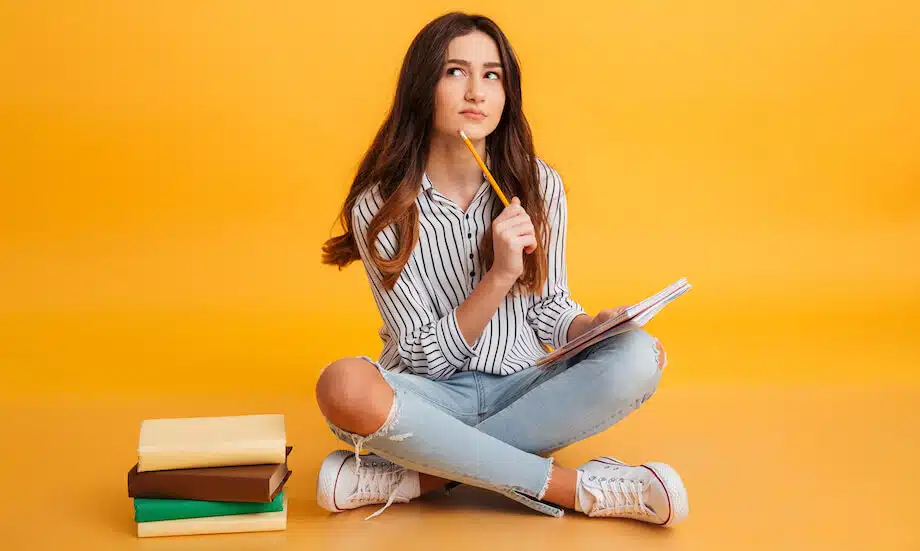 Student recalling study tips while reviewing notes