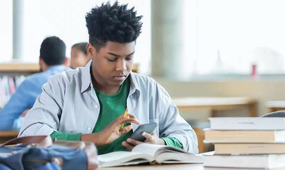 Student practices writing work neatly on chalkboard to prevent making careless math mistakes.
