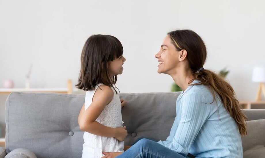 Mother using intentional language to support children at home