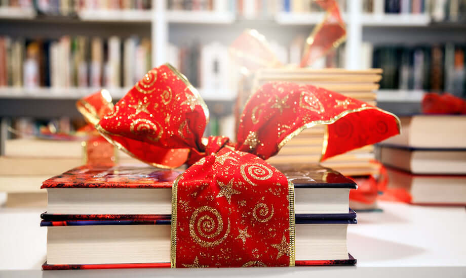 Books for kids wrapped in decorative paper and bow.
