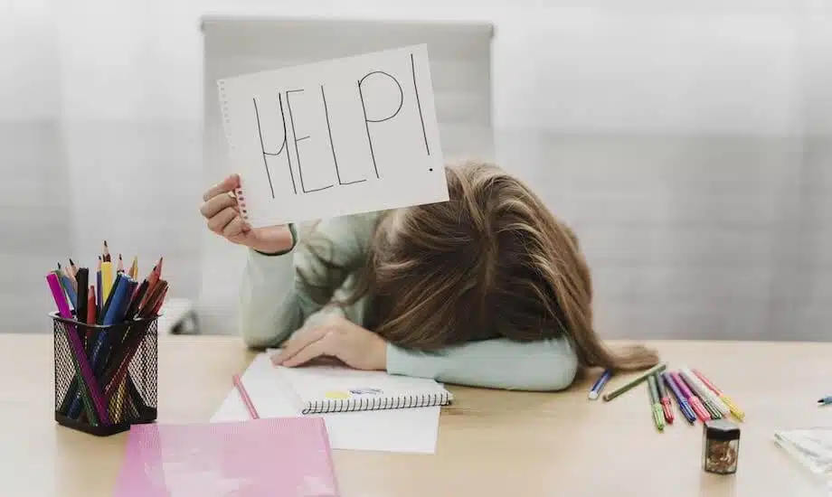 Child is stressed and holding a sign that reads "help."